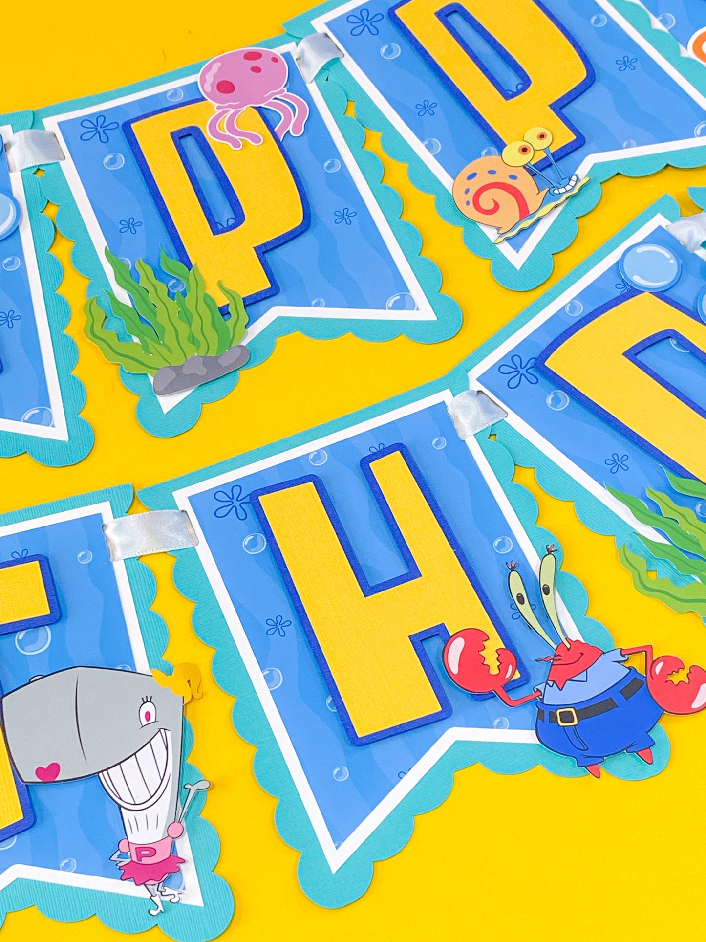 SpongeBob SquarePants happy birthday banner handmade with bright yellow blue ocean colors featuring jellyfish bubbles and underwater theme party decorations for kids birthday party backdrop dessert table decor SpongeBob birthday banner custom handmade party banner Bikini Bottom theme birthday decorations