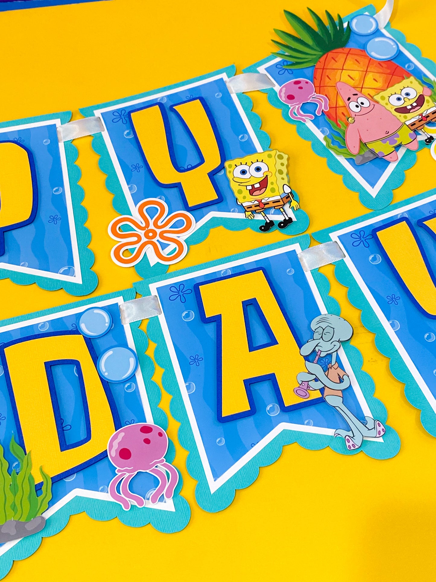 SpongeBob SquarePants happy birthday banner handmade with bright yellow blue ocean colors featuring jellyfish bubbles and underwater theme party decorations for kids birthday party backdrop dessert table decor SpongeBob birthday banner custom handmade party banner Bikini Bottom theme birthday decorations
