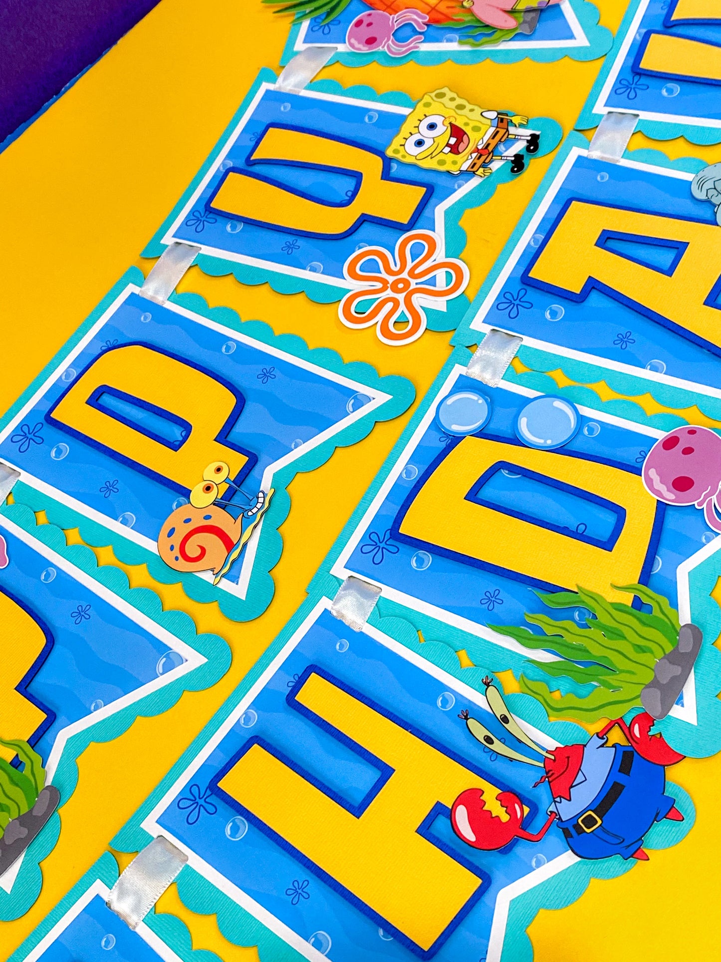 SpongeBob SquarePants happy birthday banner handmade with bright yellow blue ocean colors featuring jellyfish bubbles and underwater theme party decorations for kids birthday party backdrop dessert table decor SpongeBob birthday banner custom handmade party banner Bikini Bottom theme birthday decorations
